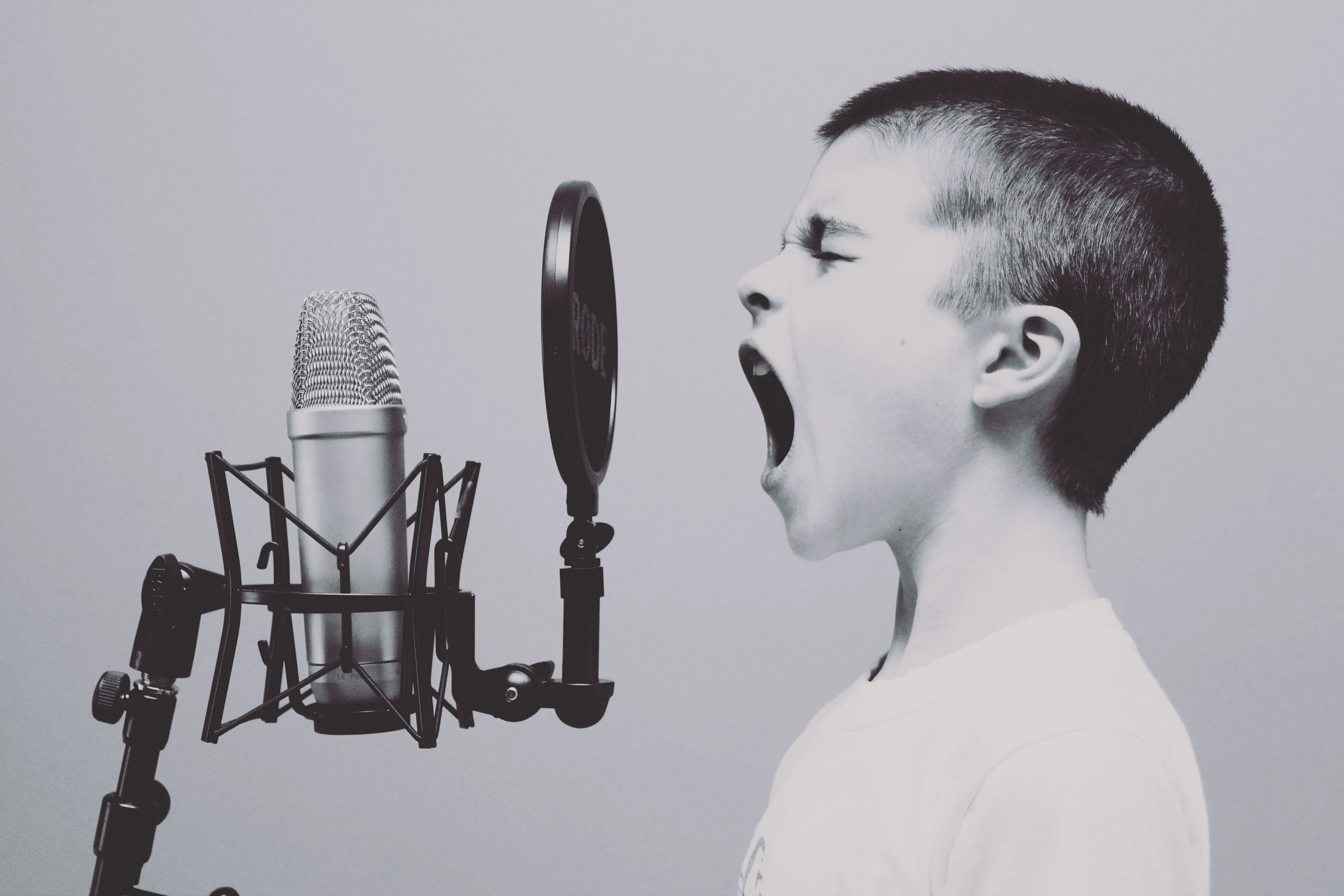Person speaking into a studio microphone