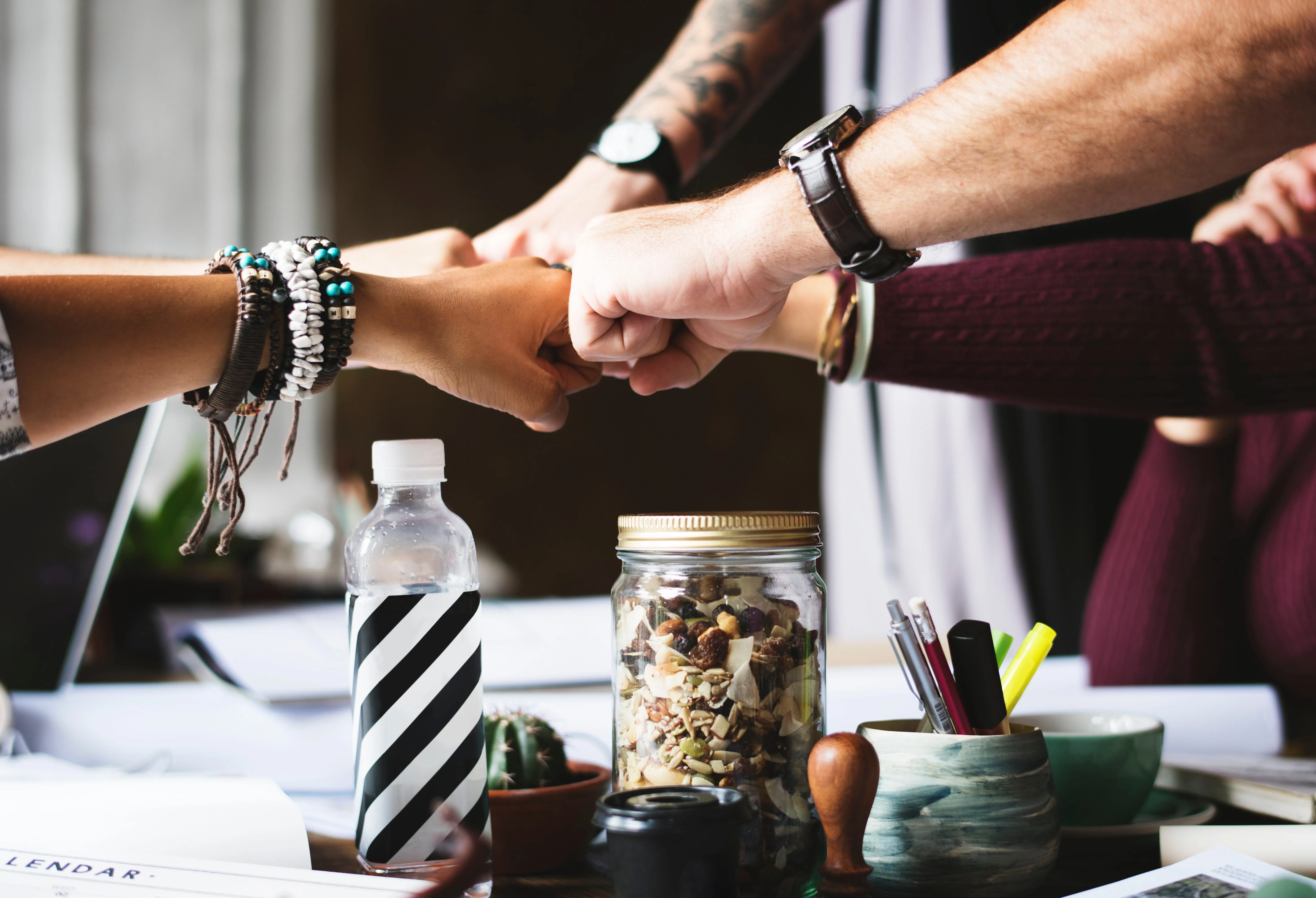 Coworkers touching fists in collaboration